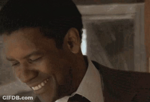Man In Suit And Tie Smiling With Closed Eyes GIF