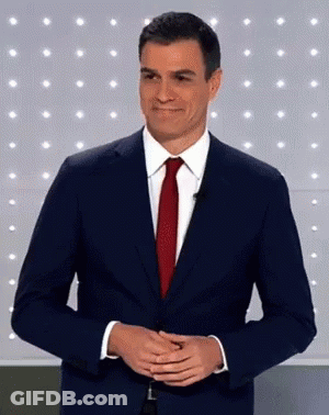 Man In Suit And Tie Smiling With Hands Folded GIF