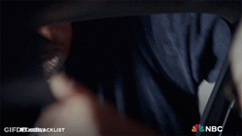 Man In Suit And Tie Smiling With NBC Logo GIF