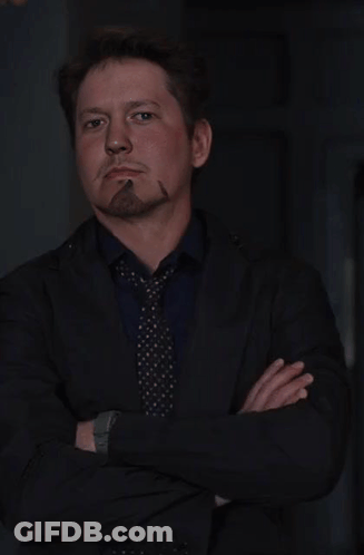Man In Suit And Tie Smoking Cigar GIF
