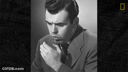 Man In Suit And Tie Smoking Cigarette Black And White GIF