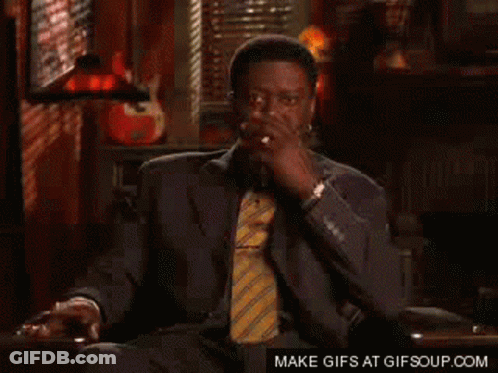 Man In Suit And Tie Smoking Cigarette GIF