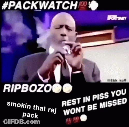 Man In Suit And Tie Smoking Into Microphone GIF