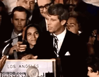 Man In Suit And Tie Speaking At Podium GIF