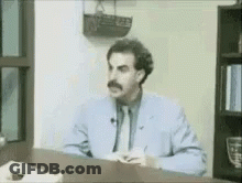 Man In Suit And Tie Speaking GIF