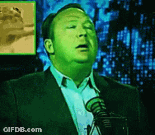 Man In Suit And Tie Speaking Into Microphone GIF
