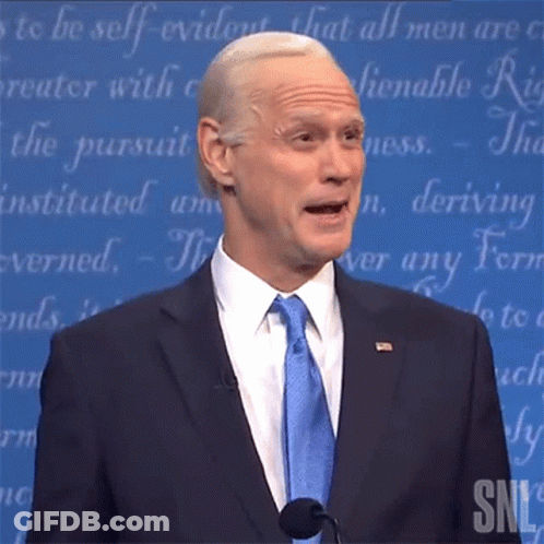 Man In Suit And Tie Speaking Microphone SNL Logo GIF