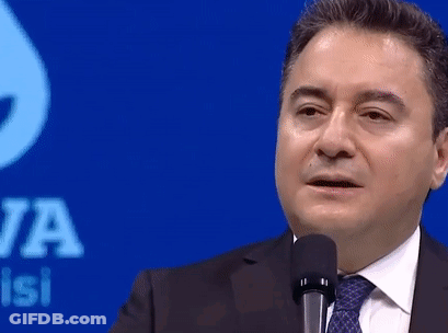 Man In Suit And Tie Standing At Microphone GIF
