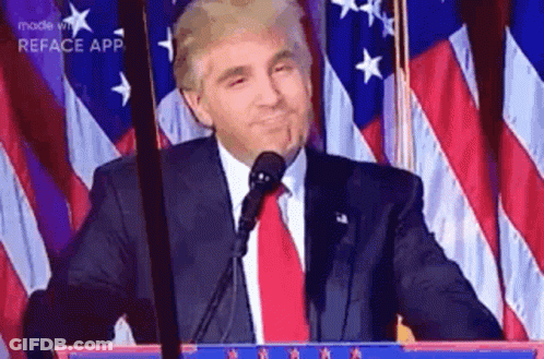 Man In Suit And Tie Standing At Microphone GIF
