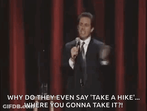 Man In Suit And Tie Standing At Microphone On Stage GIF
