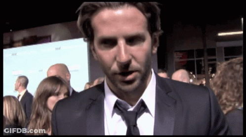 Man In Suit And Tie Standing Before Crowd GIF