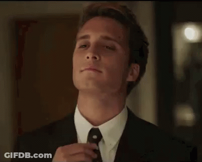 Man In Suit And Tie Standing Before Door Eyes Closed GIF