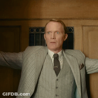 Man In Suit And Tie Standing Before Door GIF