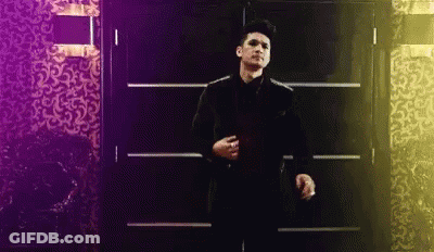 Man In Suit And Tie Standing Before Door GIF