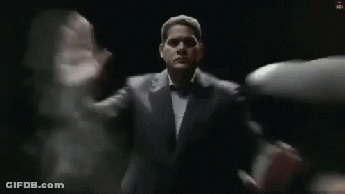Man In Suit And Tie Standing Before Group GIF