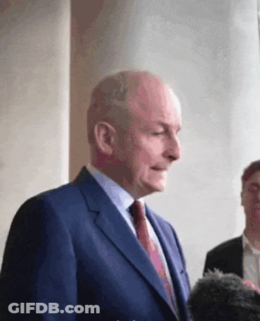 Man In Suit And Tie Standing Before Group GIF