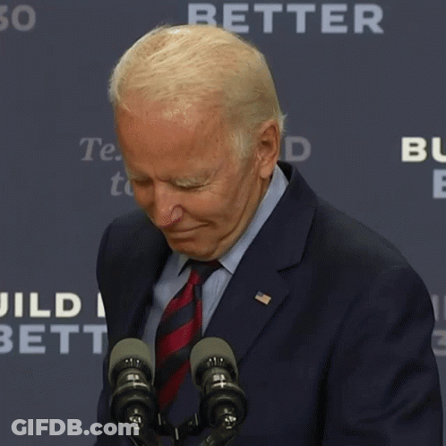 Man In Suit And Tie Standing Before Microphones GIF