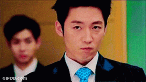 Man In Suit And Tie Standing Before Two Men GIF