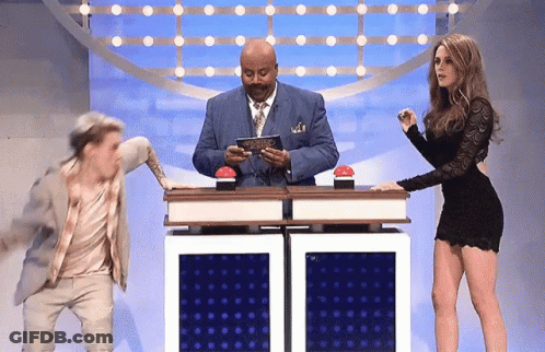 Man In Suit And Tie Standing Beside Woman In Dress GIF