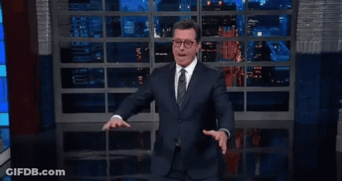 Man In Suit And Tie Standing By Window GIF