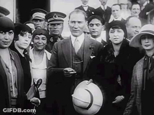 Man In Suit And Tie Standing In Crowd GIF