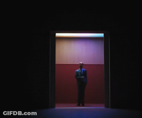 Man In Suit And Tie Standing In Elevator GIF
