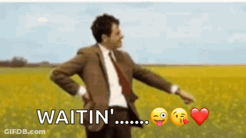 Man In Suit And Tie Standing In Field Saying Waitin GIF