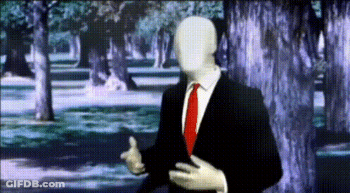 Man In Suit And Tie Standing In Forest GIF