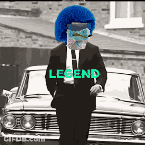 Man In Suit And Tie Standing In Front Of Car With Legend GIF