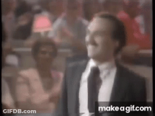 Man In Suit And Tie Standing In Front Of Crowd GIF