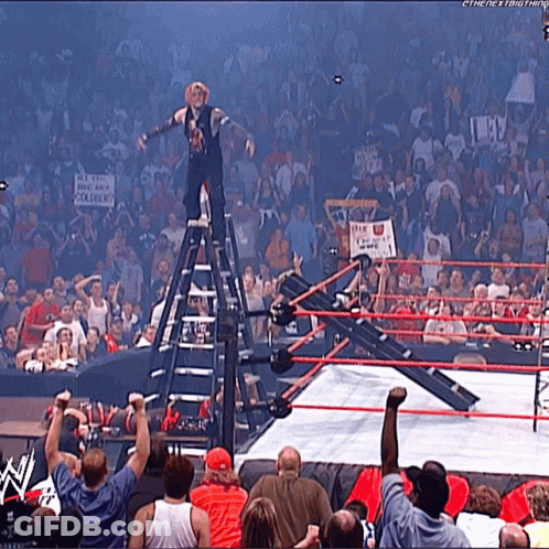 Man In Suit And Tie Standing In Front Of DJ Booth GIF