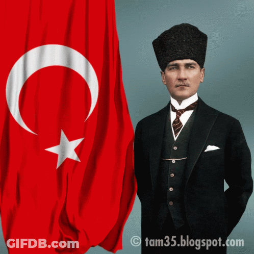 Man In Suit And Tie Standing In Front Of Flag GIF
