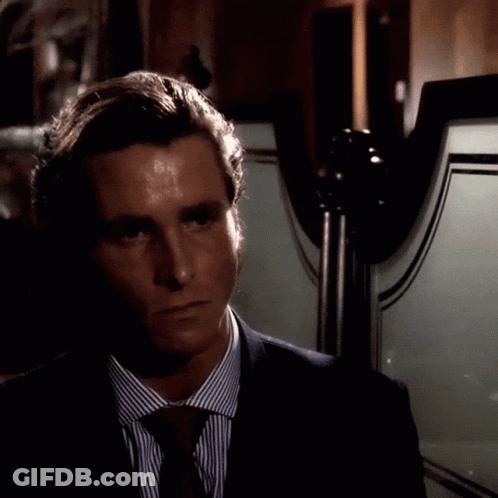 Man In Suit And Tie Standing In Front Of Mirror GIF