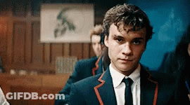 Man In Suit And Tie Standing In Front Of Sign S GIF