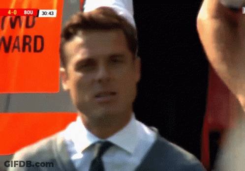 Man In Suit And Tie Standing In Front Of Ward Sign GIF