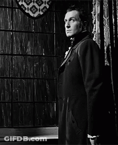 Man In Suit And Tie Standing In Front Of Window Black And White GIF