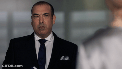 Man In Suit And Tie Standing In Front Of Window GIF