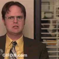 Man In Suit And Tie Standing In Front Of Window With Blinds GIF