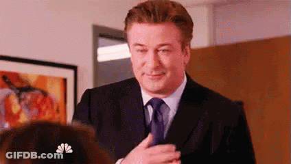Man In Suit And Tie Standing In Front Of Woman GIF