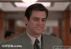 Man In Suit And Tie Standing In Hallway GIF