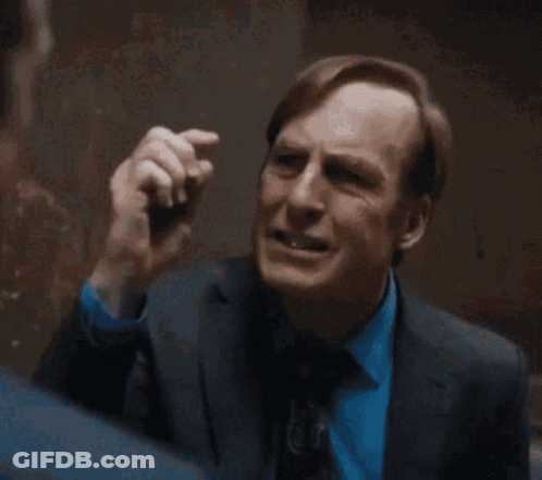 Man In Suit And Tie Standing In Room GIF