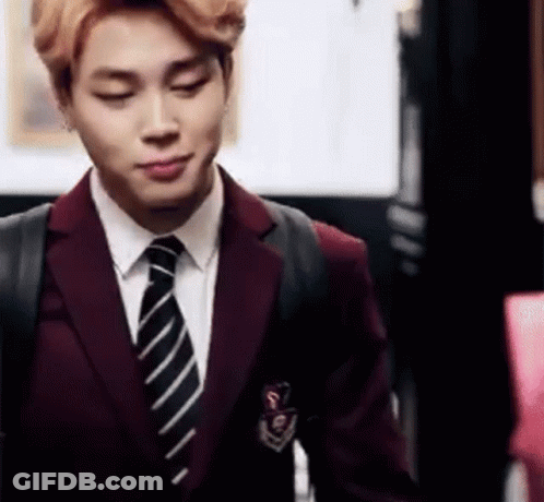 Man In Suit And Tie Standing In Room GIF