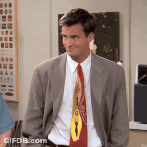 Man In Suit And Tie Standing In Room GIF