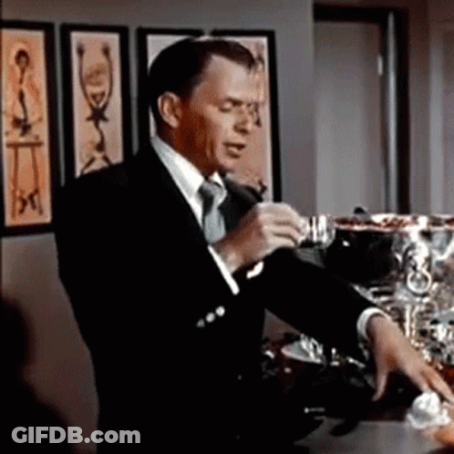 Man In Suit And Tie Standing In Room GIF