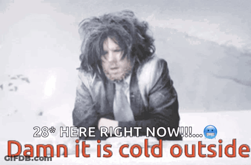 Man In Suit And Tie Standing In Snow GIF