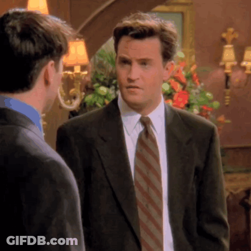 Man In Suit And Tie Standing Next To Another Man GIF
