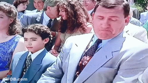 Man In Suit And Tie Standing Next To Boy In Blue Suit GIF