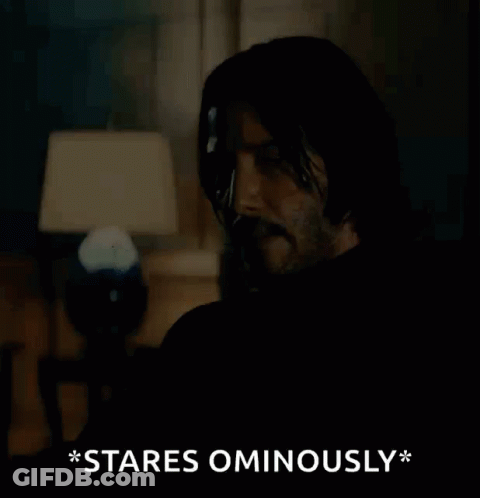 Man In Suit And Tie Staring Ominously GIF