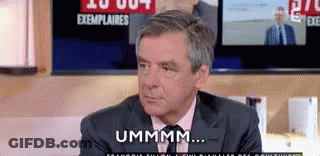 Man In Suit And Tie Talking By TV GIF