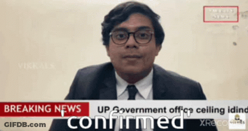 Man In Suit And Tie Talking In Front Of Breaking News Sign GIF